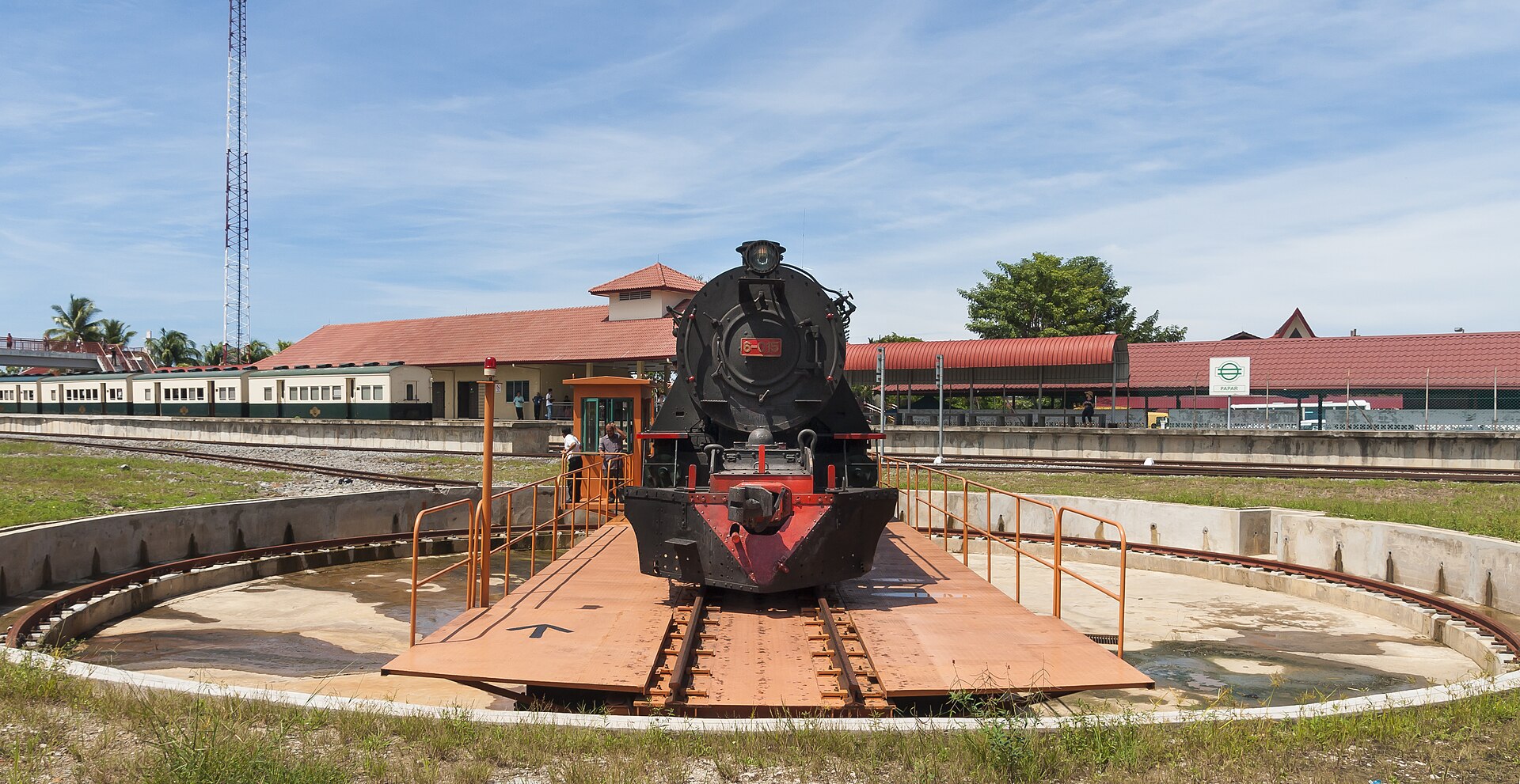 A steam locomotive sits on a railway turntable in Papar, Sabah, ready to be turned around and sent back the way it came.